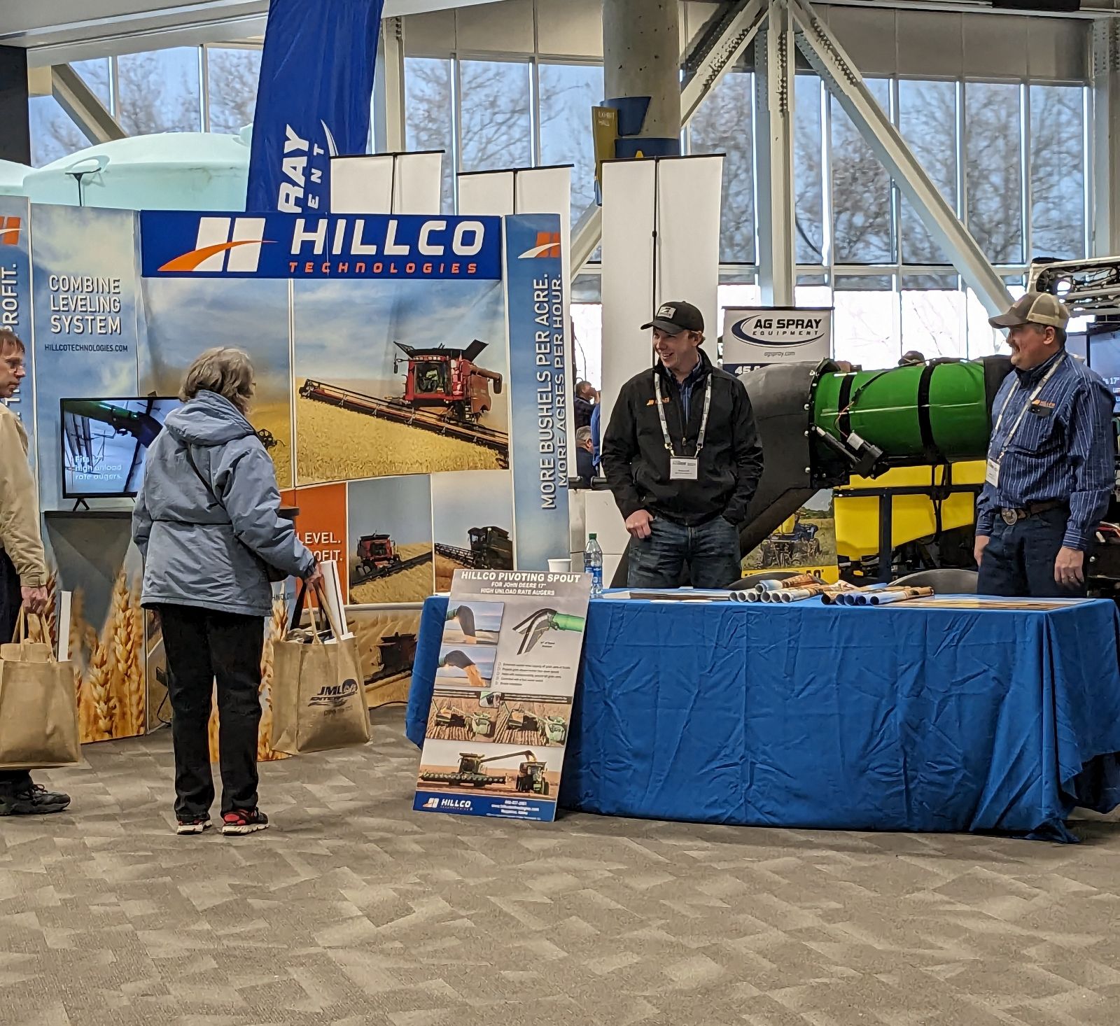 Preston, Sales Director, and Kolten, Salesman, visiting with customers at the 2024 Spokane Ag Expo