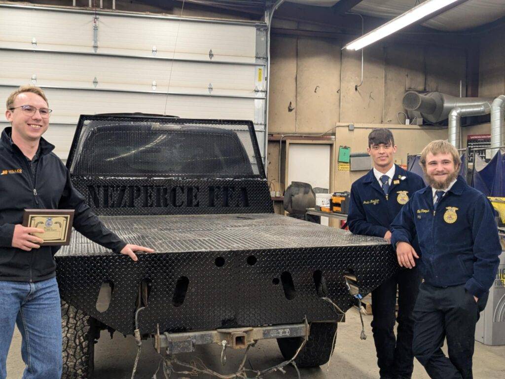 Sales Director Preston Hill with Nezperce FFA students and custom flatbed built with help from Hillco