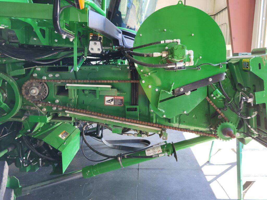 Exposed feederhouse chain drive during disassembly of the John Deere X9