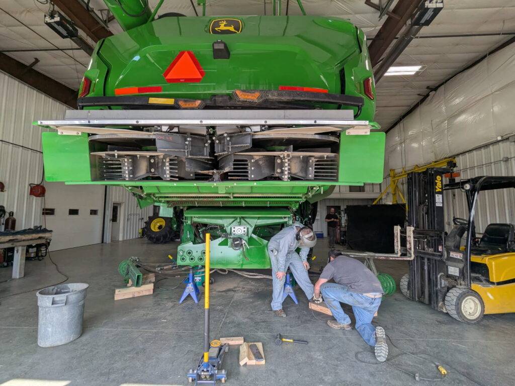 Hillco technicians replacing the X9 rear axle with a Hillco drop axle